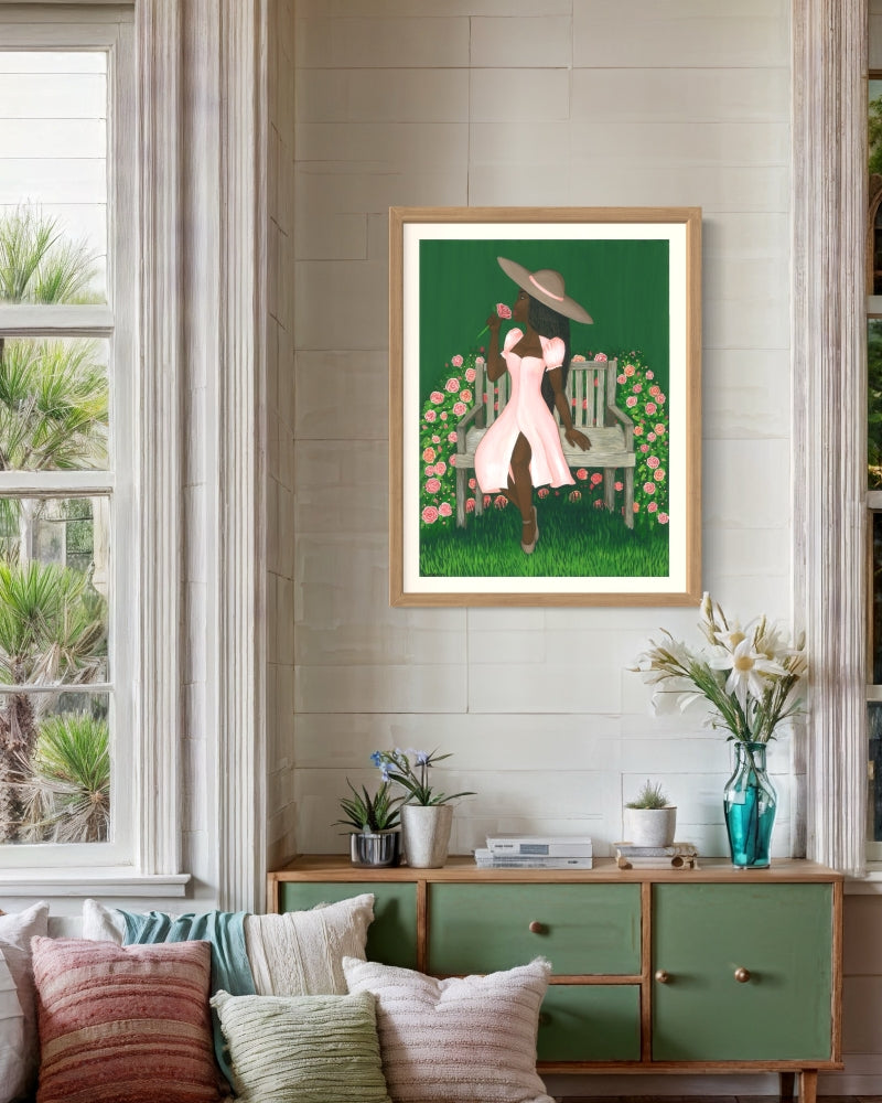 Framed print of Black woman with natural hair surrounded by lush rose garden, painted in gouache.